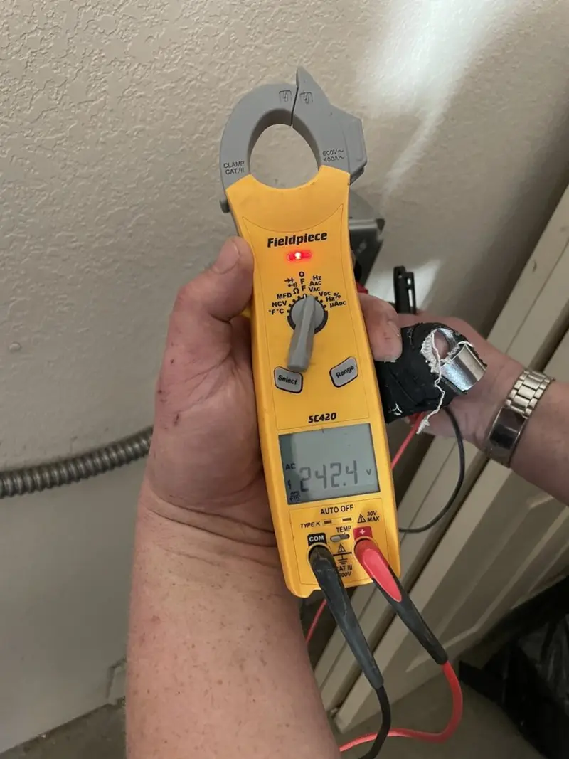 Voltage testing with clamp meter during Outlet Installation in Mounds View